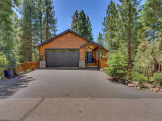 Nestled among tall pine trees, this charming wooden home offers a picturesque mountain retreat.