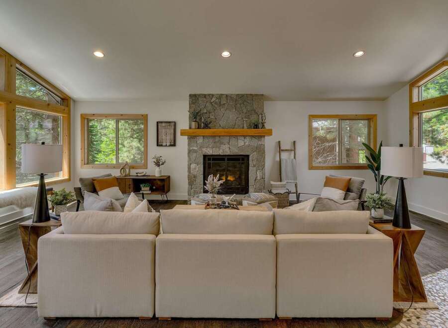 Experience cozy living in this inviting living room, featuring a stunning stone fireplace as the centerpiece.