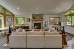 Experience cozy living in this inviting living room, featuring a stunning stone fireplace as the centerpiece.