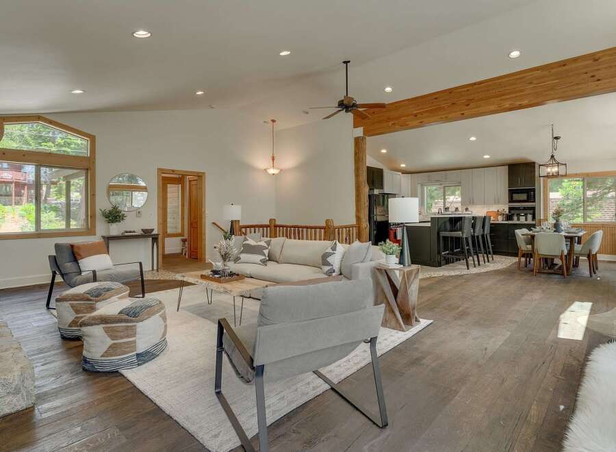 Experience modern mountain living in this stunning open-concept home, featuring a spacious living area with a cozy fireplace and large windows that flood the space with natural light.