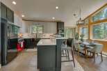 Experience modern living in this stunning kitchen featuring sleek gray cabinetry, a vibrant red range, and a spacious island perfect for entertaining.