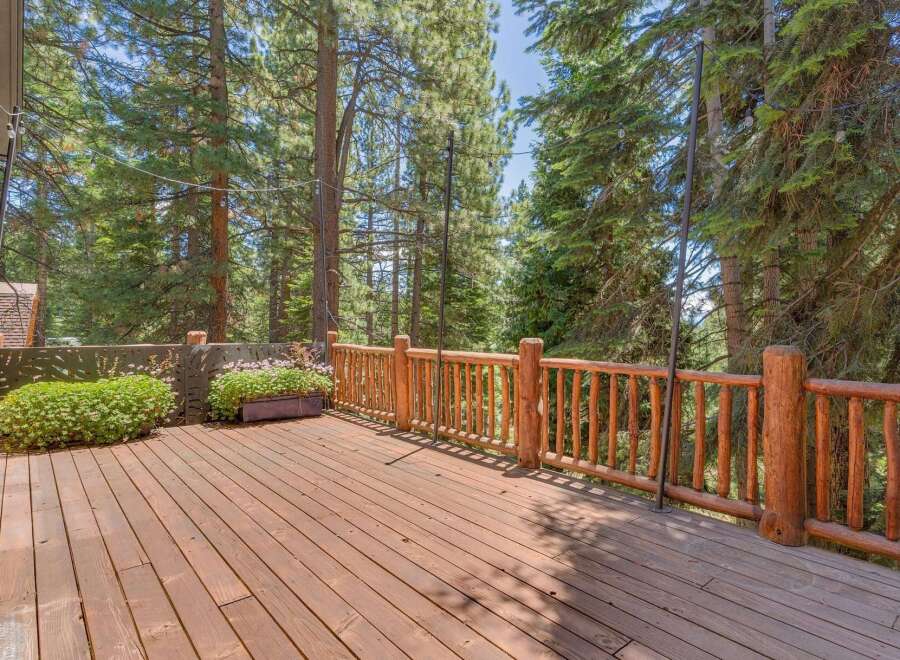 Enjoy the serene mountain views from this expansive wooden deck, perfect for outdoor entertaining or quiet relaxation.