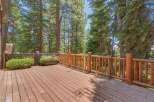 Enjoy the serene mountain views from this expansive wooden deck, perfect for outdoor entertaining or quiet relaxation.