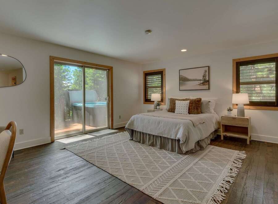 Experience ultimate relaxation in this serene bedroom featuring a luxurious hot tub accessible directly from the room.