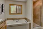 Indulge in relaxation in this luxurious bathroom, featuring a spacious jetted tub perfect for unwinding after a long day.