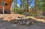 Escape to this charming mountain retreat featuring a rustic wooden exterior and a serene backyard oasis.