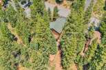 Nestled amidst towering pine trees, this charming cabin offers a serene mountain retreat.