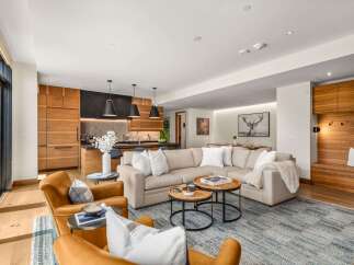 Experience modern luxury in this open-concept living space, featuring a spacious sectional sofa perfect for gatherings.