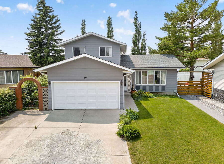 Discover this charming home featuring a welcoming facade with a large garage and a beautifully landscaped front yard.