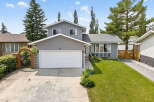 Discover this charming home featuring a welcoming facade with a large garage and a beautifully landscaped front yard.