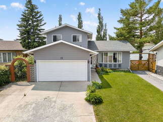 Discover this charming home featuring a welcoming facade with a large garage and a beautifully landscaped front yard.