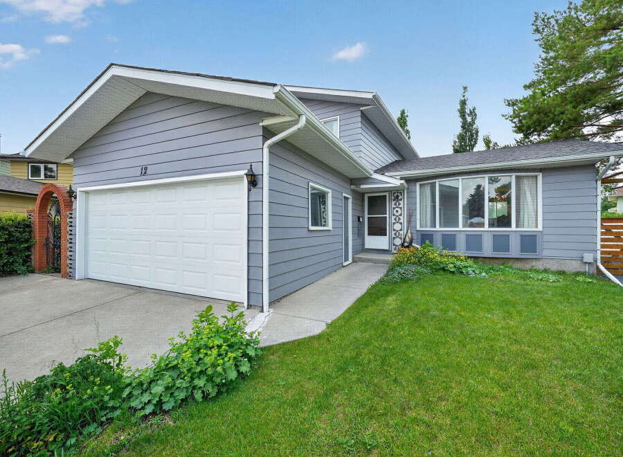 Charming single-family home featuring a spacious two-car garage and a welcoming front entrance.