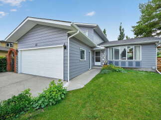 Charming single-family home featuring a spacious two-car garage and a welcoming front entrance.