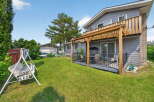 Enjoy outdoor living with this spacious backyard featuring a covered deck perfect for entertaining and a charming swing set for relaxation.