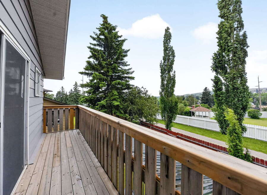 Enjoy outdoor living on this charming wooden deck, perfect for relaxing or entertaining.