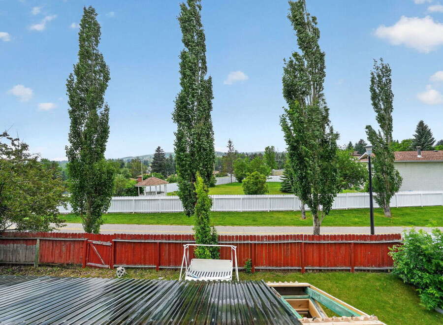 Enjoy the serene backyard views from this property, featuring tall, slender trees that provide ample privacy and a touch of natural elegance.