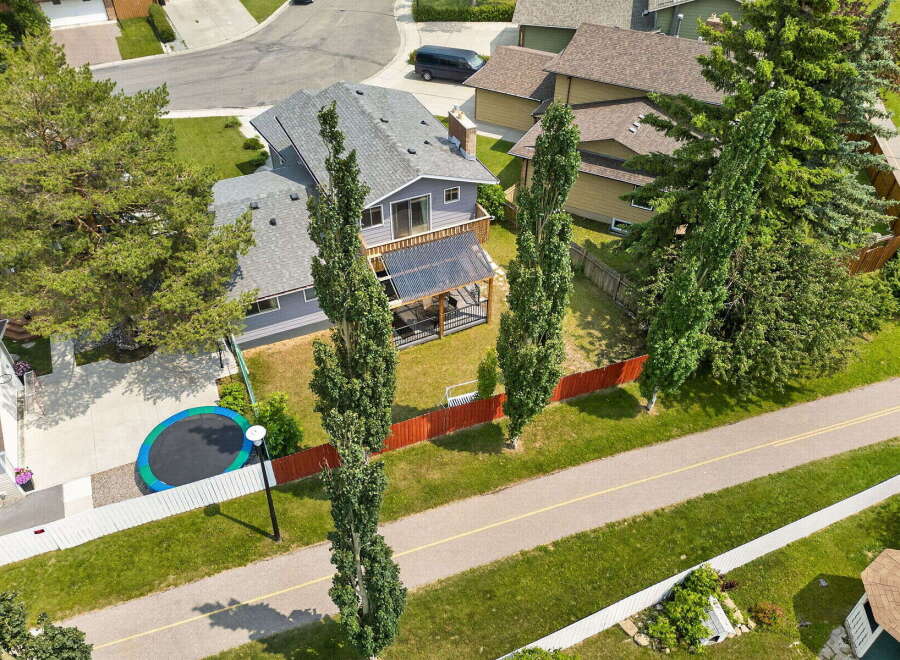 Discover this charming home featuring a spacious backyard with a trampoline, perfect for outdoor fun.