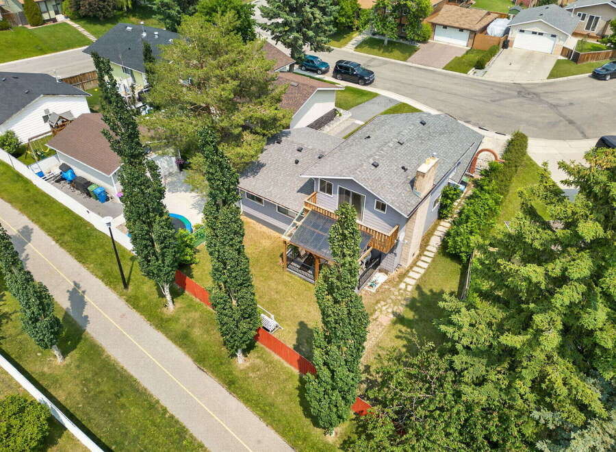 Discover this charming home featuring a spacious backyard with a covered deck, perfect for outdoor entertaining.