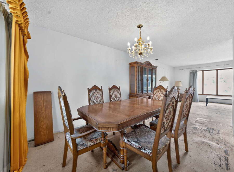 This formal dining room features a classic wooden dining table with upholstered chairs, perfect for hosting gatherings.