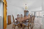 This formal dining room features a classic wooden dining table with upholstered chairs, perfect for hosting gatherings.