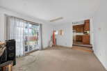 This spacious living area offers a bright and airy atmosphere with large sliding glass doors leading to an outdoor patio.