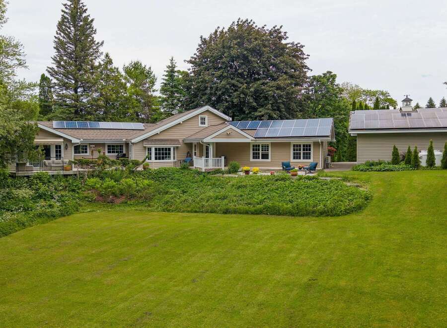 Discover this charming home featuring a spacious lawn and lush landscaping, perfect for outdoor enjoyment.