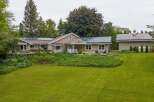 Discover this charming home featuring a spacious lawn and lush landscaping, perfect for outdoor enjoyment.