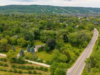 Discover this stunning property nestled amidst lush greenery, offering a serene escape with ample space for outdoor enjoyment.