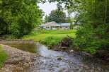 Experience serene living with this charming home nestled beside a babbling brook.