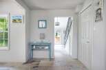 Step into this charming entryway featuring a bright blue console table adorned with decorative accents and a crystal lamp.