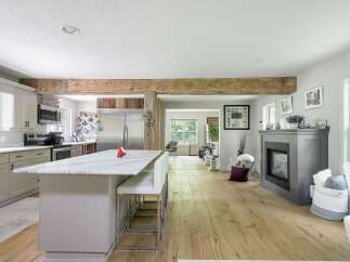 Experience modern living in this open-concept home featuring a stunning marble-topped island perfect for entertaining.