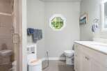 This bright and airy bathroom features a spacious walk-in shower with elegant tilework and a modern glass door.