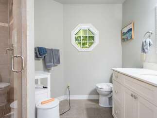 This bright and airy bathroom features a spacious walk-in shower with elegant tilework and a modern glass door.