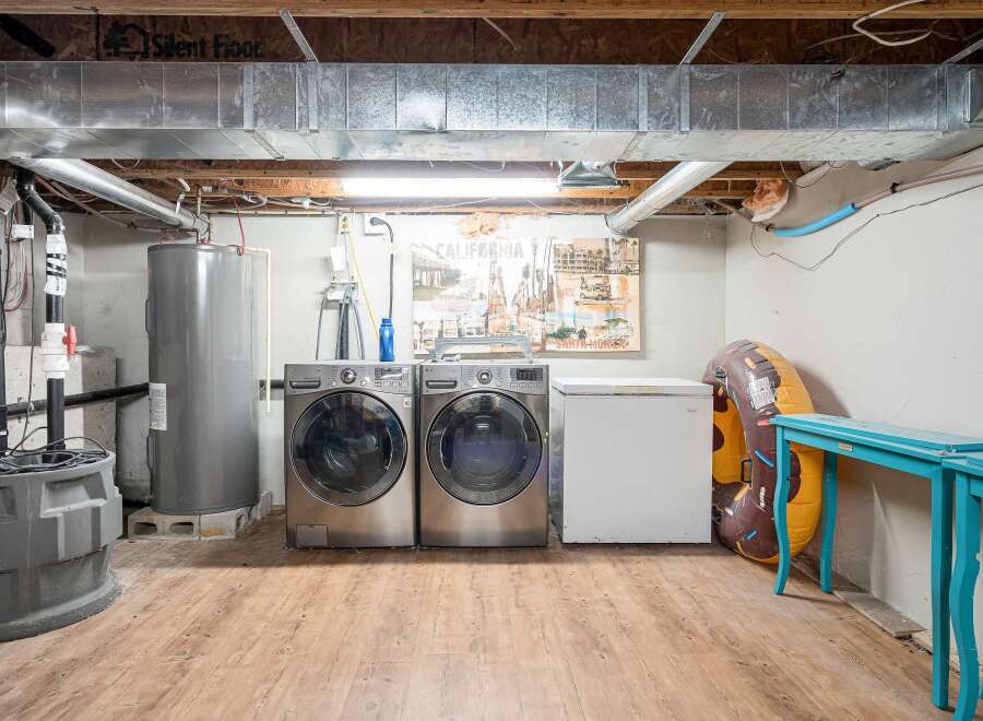 Discover the practical side of this home with a dedicated laundry area featuring a large-capacity washer and dryer.