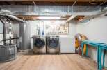 Discover the practical side of this home with a dedicated laundry area featuring a large-capacity washer and dryer.