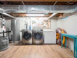 Discover the practical side of this home with a dedicated laundry area featuring a large-capacity washer and dryer.