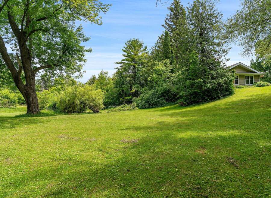 Discover this charming home nestled on a picturesque, tree-lined lot.