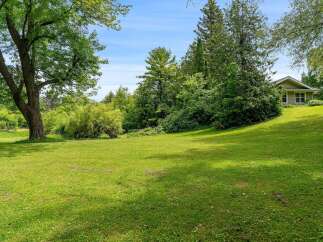 Discover this charming home nestled on a picturesque, tree-lined lot.