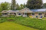 Discover this charming home featuring a modern roof with solar panels, perfect for sustainable living.