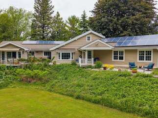 Discover this charming home featuring a modern roof with solar panels, perfect for sustainable living.