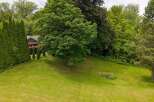 Discover this charming property featuring a well-maintained lawn and lush greenery, perfect for outdoor enjoyment.
