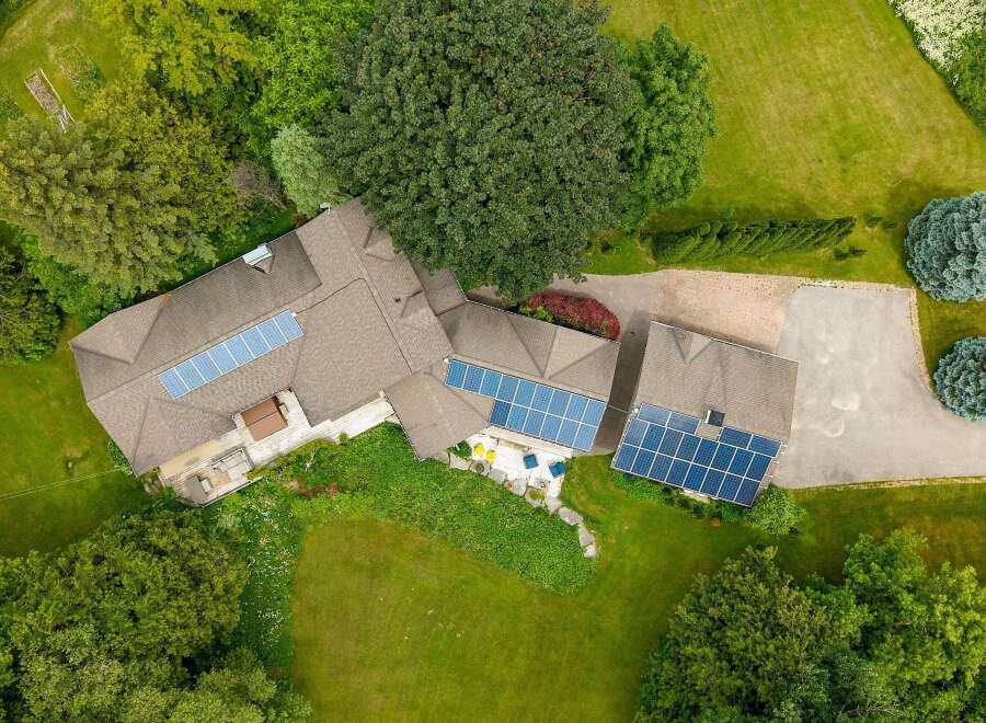 Experience sustainable living with this stunning property featuring a large roof adorned with solar panels, maximizing energy efficiency.