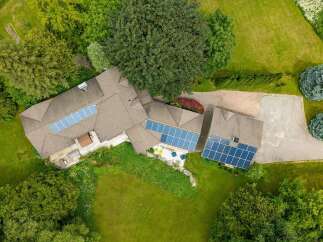 Experience sustainable living with this stunning property featuring a large roof adorned with solar panels, maximizing energy efficiency.