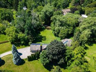Discover this stunning property nestled amidst lush greenery, featuring a modern home equipped with solar panels for sustainable living.
