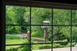 Enjoy serene living with this picturesque view of a flowing creek and lush greenery right from your window.