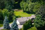 Nestled amidst lush greenery and mature trees, this property offers a serene retreat with a charming home and a tranquil stream.