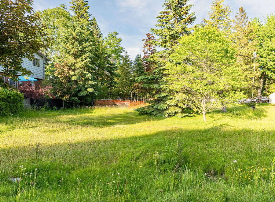Discover a spacious, sun-drenched yard perfect for outdoor enjoyment and potential expansion.