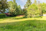 Discover a spacious, sun-drenched yard perfect for outdoor enjoyment and potential expansion.