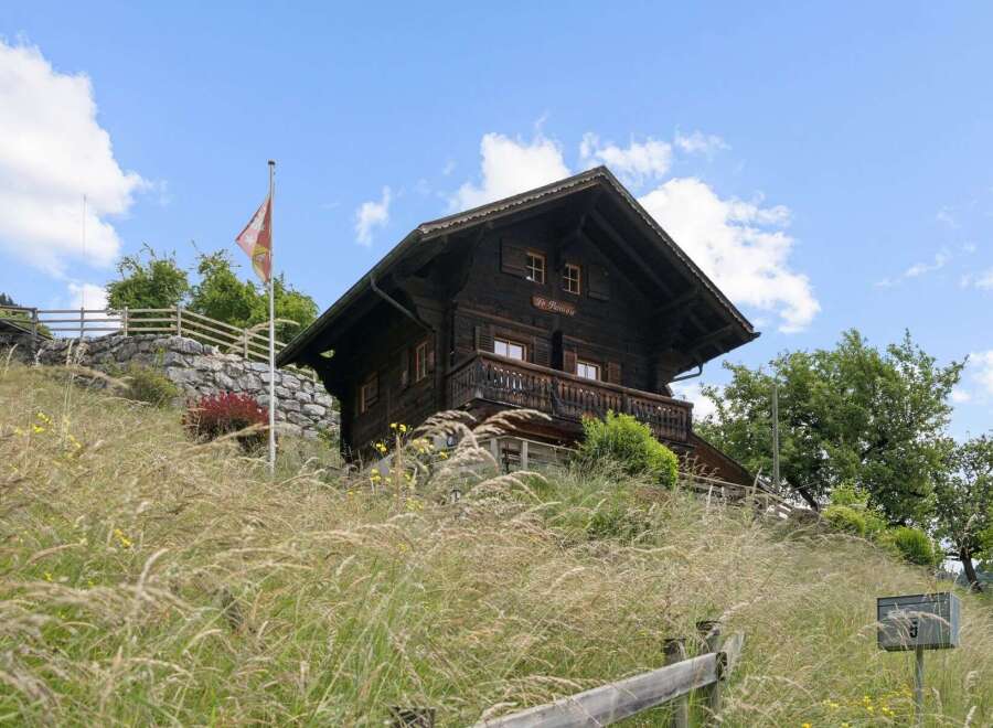 Nestled amidst lush greenery, this charming wooden chalet offers a serene mountain retreat.