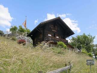 Nestled amidst lush greenery, this charming wooden chalet offers a serene mountain retreat.